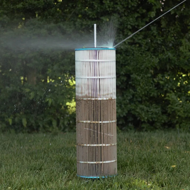 A pool cartridge filter spinning on the Cyclone stand while water sprays between the pleats